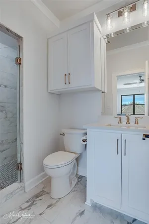 a bathroom with a toilet sink and mirror