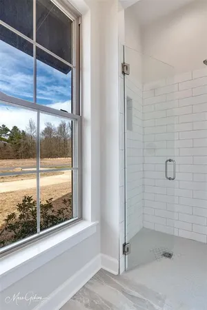 a bathroom with a glass shower door