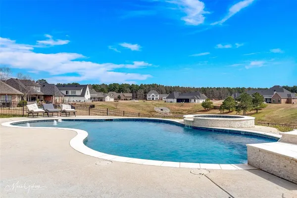 a view of swimming pool with outdoor seating and ocean view