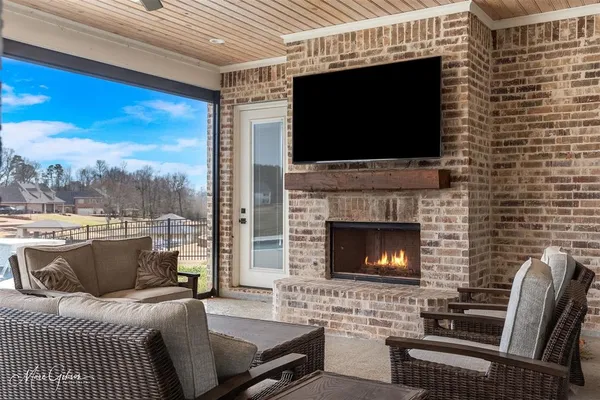 a living room with a fireplace and a flat screen tv