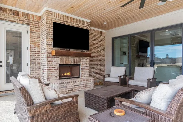 a living room with furniture a flat screen tv and a fireplace