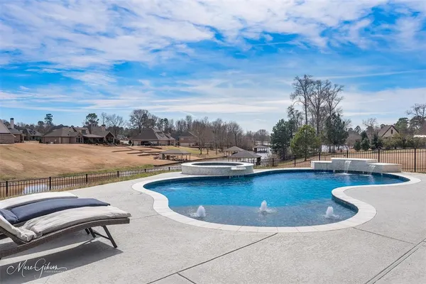 a view of a swimming pool with a lounge chair