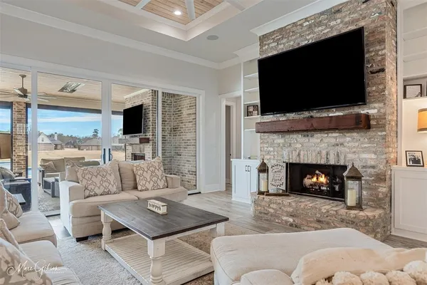 a living room with furniture a flat screen tv and a fireplace