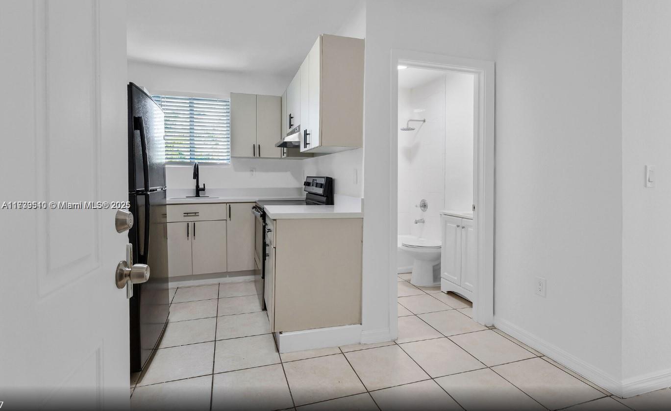 121 Northeast 55th Street Miami, FL 33137 - Photo 16 of 16 a spacious bathroom with a sink a toilet and shower