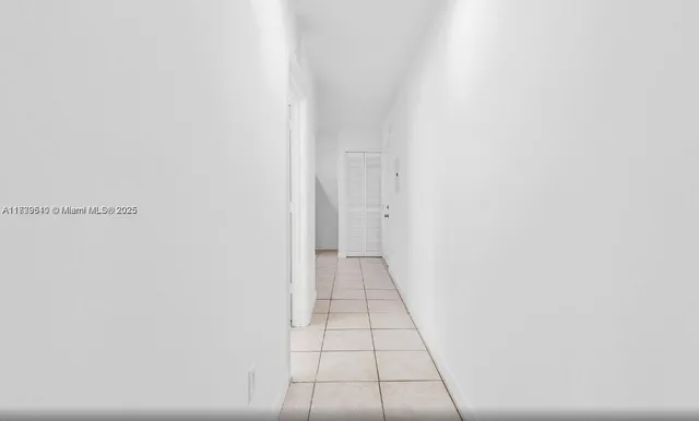 a kitchen with a refrigerator and a sink