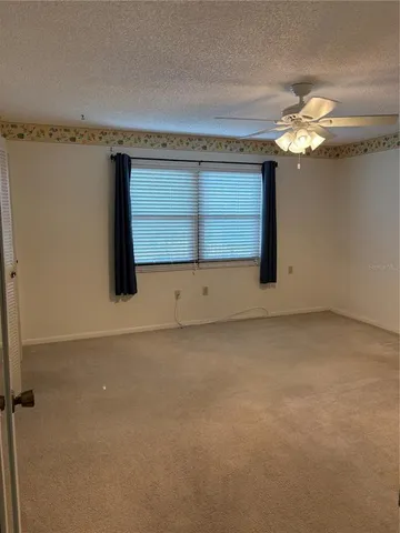 a view of a small space with wooden floor and a window