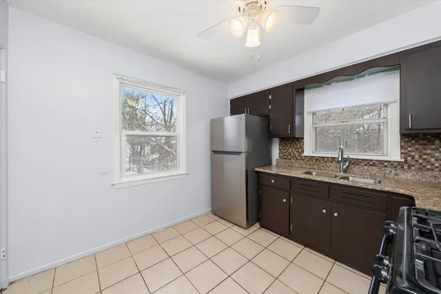 a spacious bathroom with a granite countertop sink a mirror and a shower