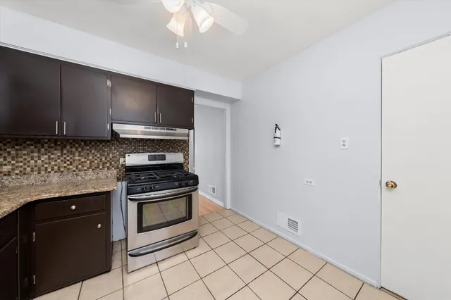 a kitchen with granite countertop a stove and a sink