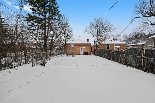 a view of house with a yard covered in snow