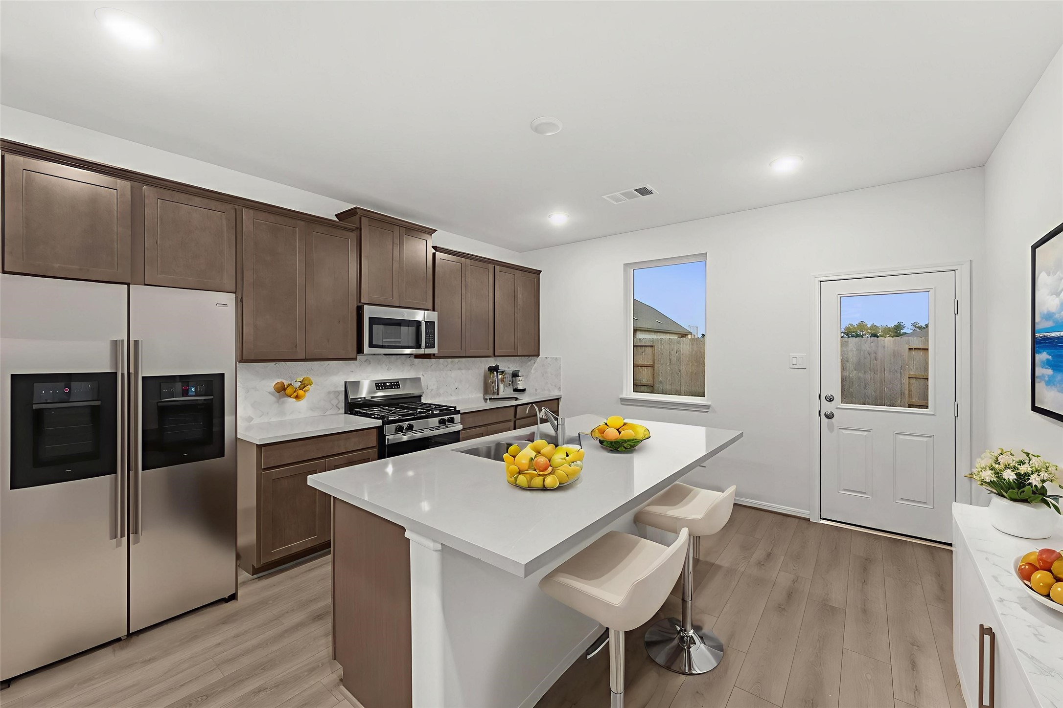 19111 Hazel Firs Court Magnolia, TX 77355 - Photo 2 of 34 a kitchen with a sink a counter top space and stainless steel appliances