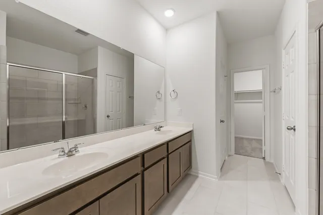 a bathroom with a double vanity sink and mirror