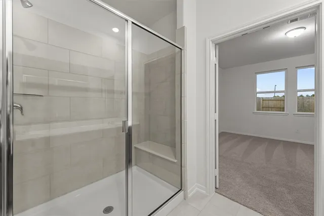 a bathroom with a bathtub and shower
