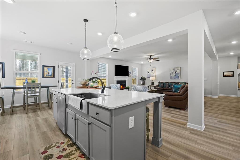 3258 Thicket Lane Atlanta, GA 30349 - Photo 11 of 38 a large kitchen with a counter space a sink appliances and living room view