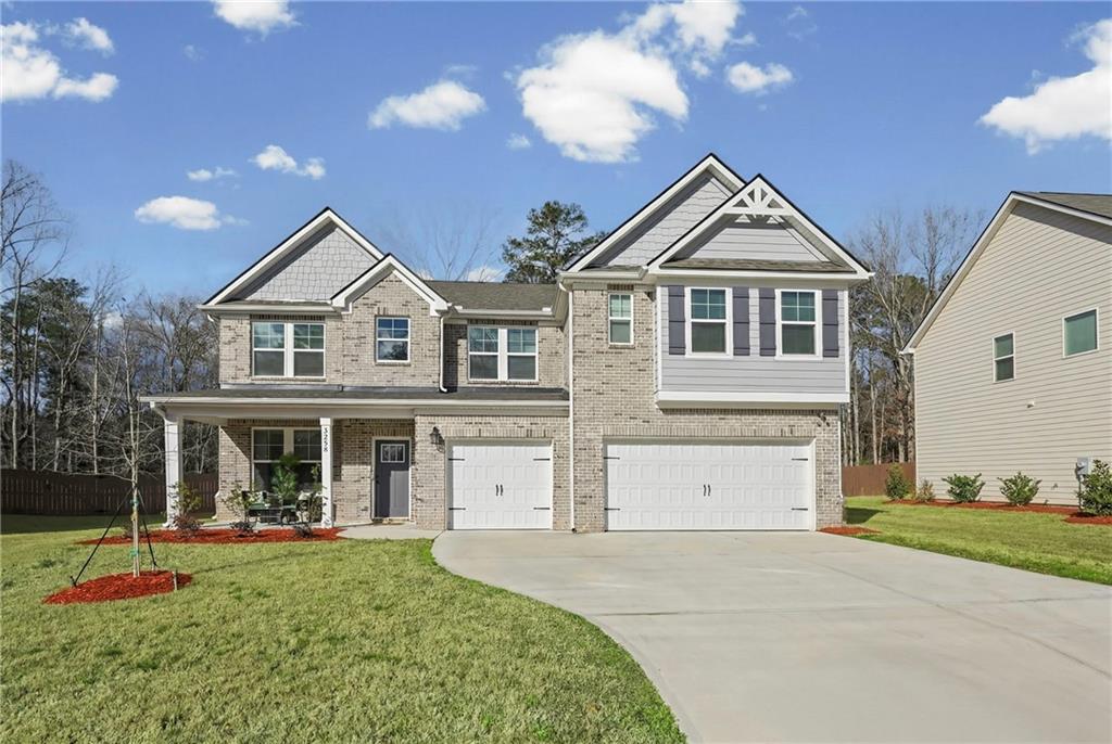 3258 Thicket Lane Atlanta, GA 30349 - Photo 2 of 38 a front view of a house with a yard