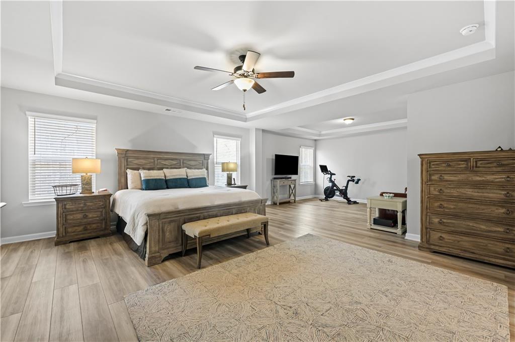 3258 Thicket Lane Atlanta, GA 30349 - Photo 21 of 38 a spacious bedroom with a large bed and ceiling fan