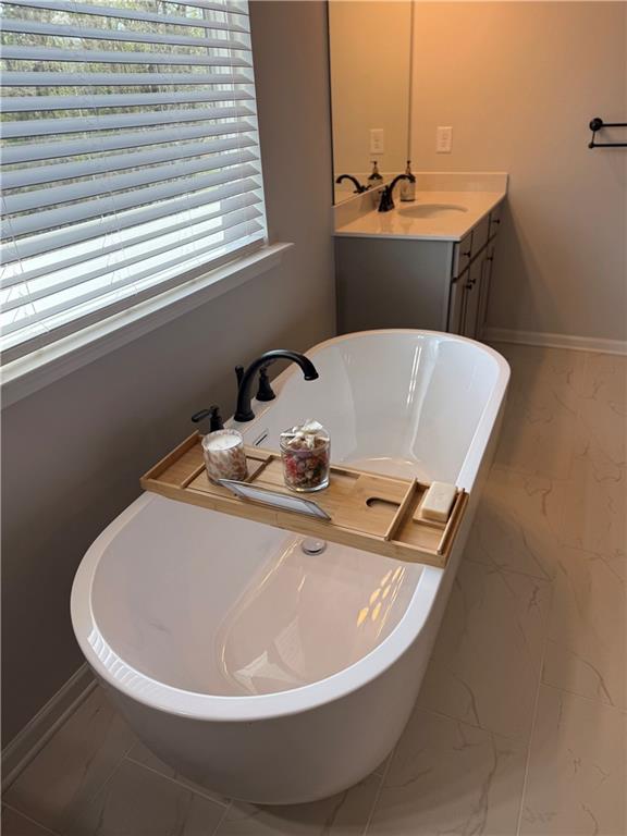 3258 Thicket Lane Atlanta, GA 30349 - Photo 25 of 38 a white bath tub sitting in a bathroom