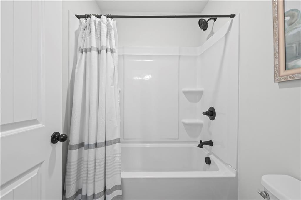 3258 Thicket Lane Atlanta, GA 30349 - Photo 28 of 38 a bathroom with a bathtub and a shower