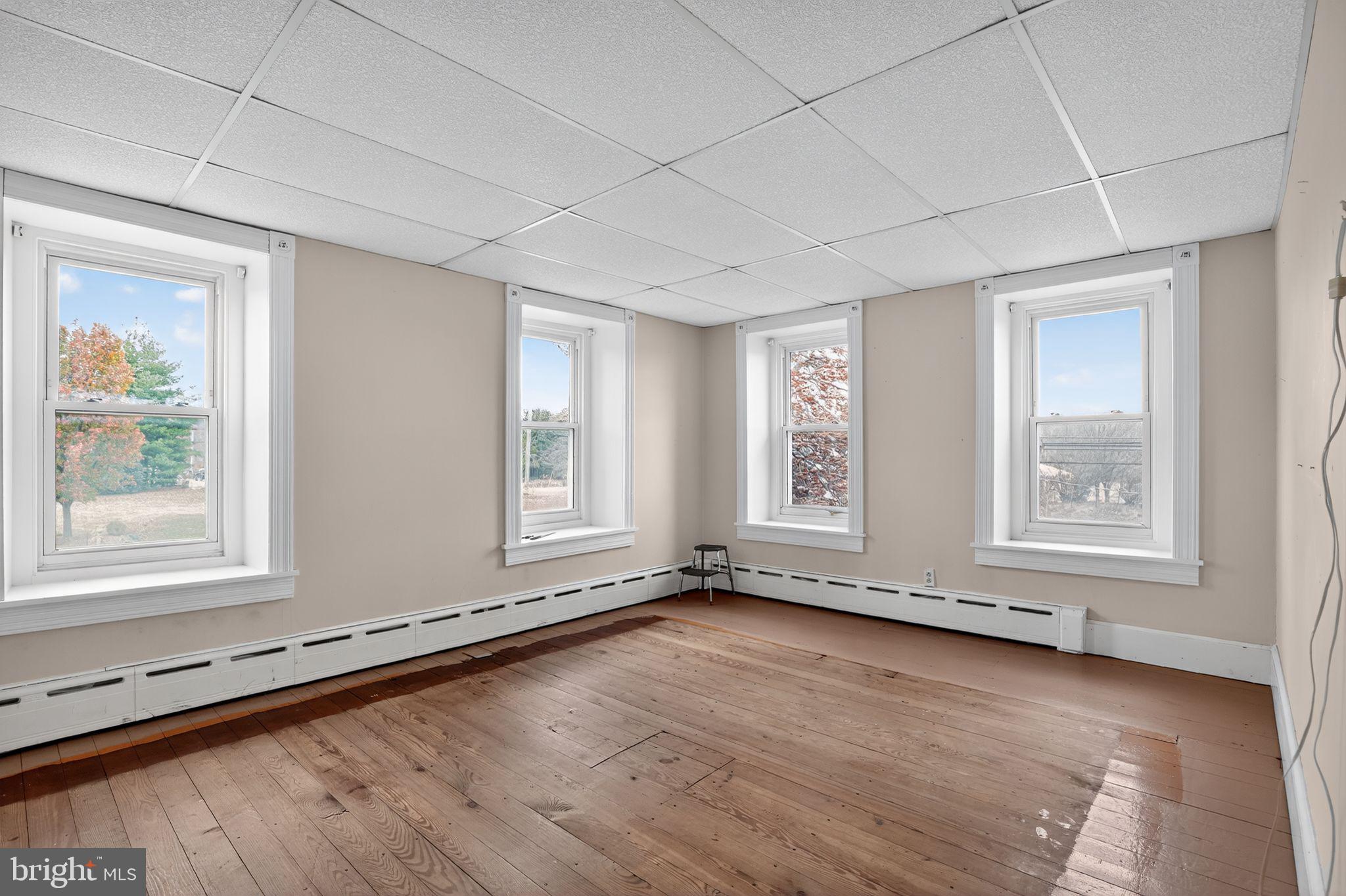411 Swamp Pike Pottstown, PA 19464 - Photo 13 of 41 an empty room with wooden floor and windows