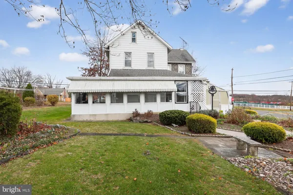a view of a house with a backyard and a garden