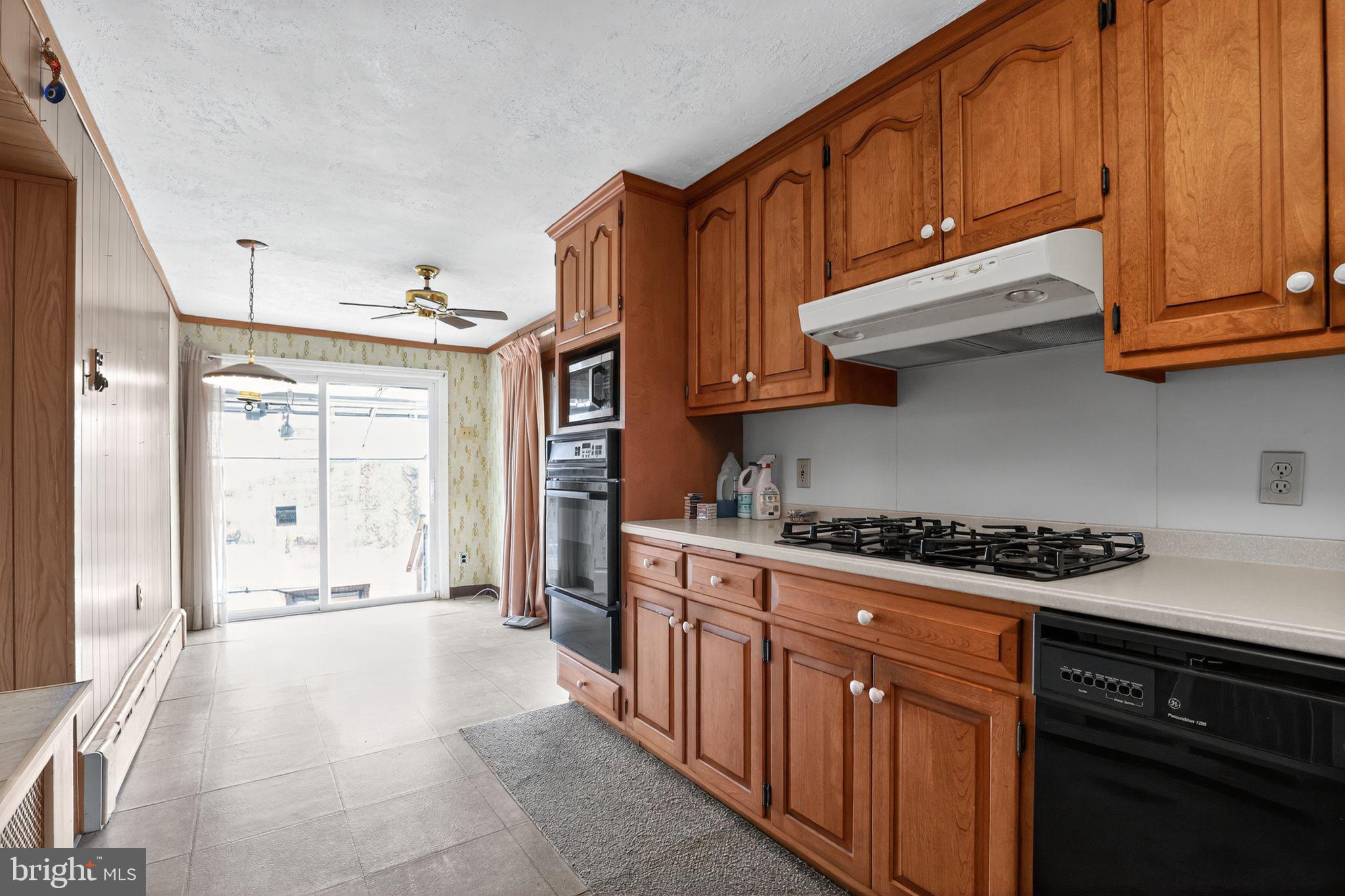 411 Swamp Pike Pottstown, PA 19464 - Photo 5 of 41 a kitchen with stainless steel appliances granite countertop a stove top oven a sink dishwasher and cabinets with wooden floor