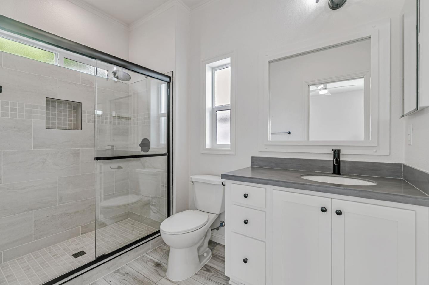 555 Umbarger Road, Unit 131 San Jose, CA 95111 - Photo 28 of 32 a bathroom with a granite countertop sink a toilet and shower