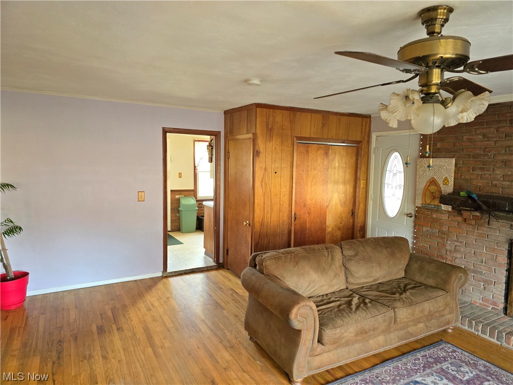 1450 Bonnie Road Macedonia, OH 44056 - Photo 18 of 21 Living room featuring a brick fireplace, light hardwood / wood-style floors, and ceiling fan