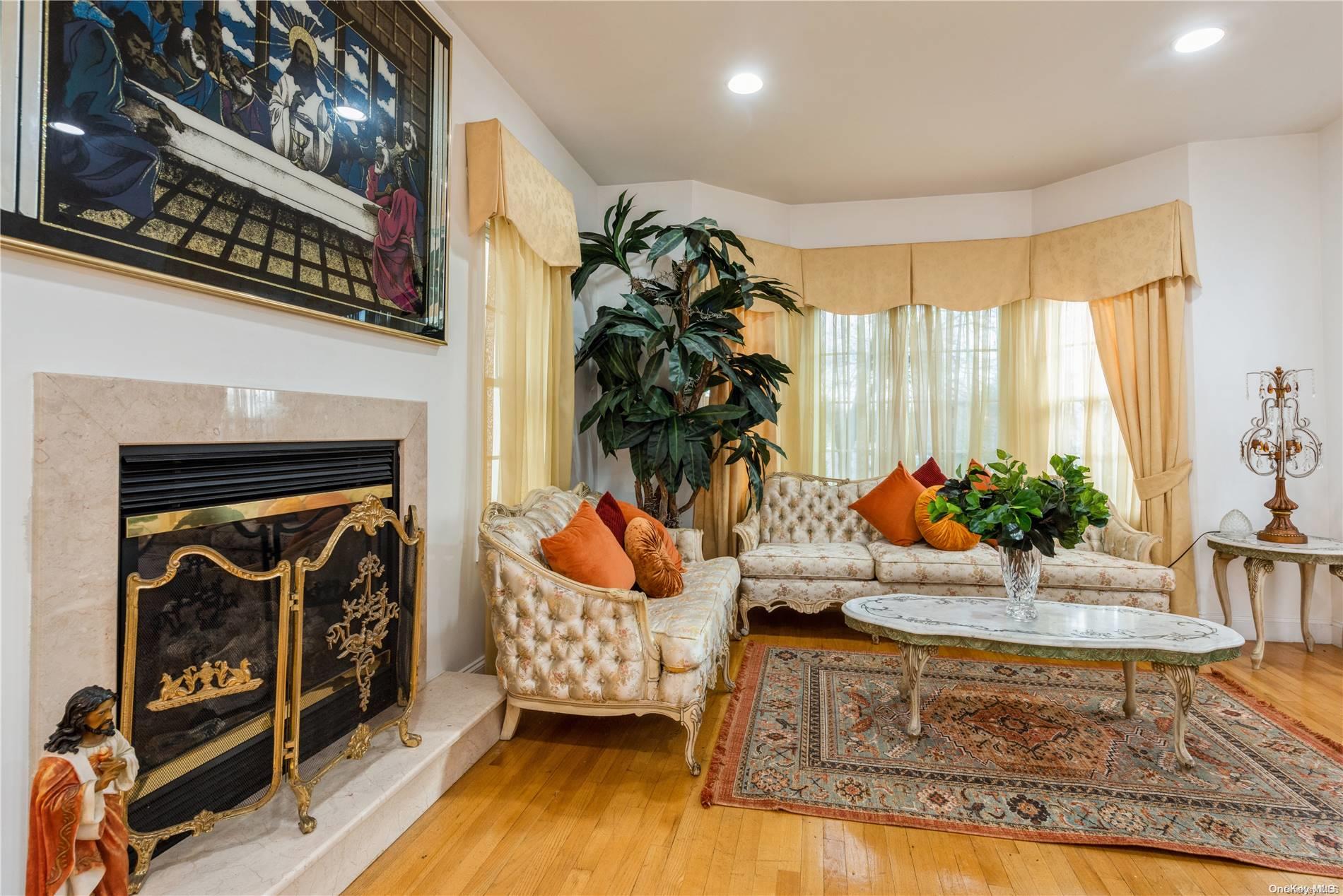 968 Bowe Road Valley Stream, NY 11580 - Photo 11 of 36 a living room with furniture and a fireplace