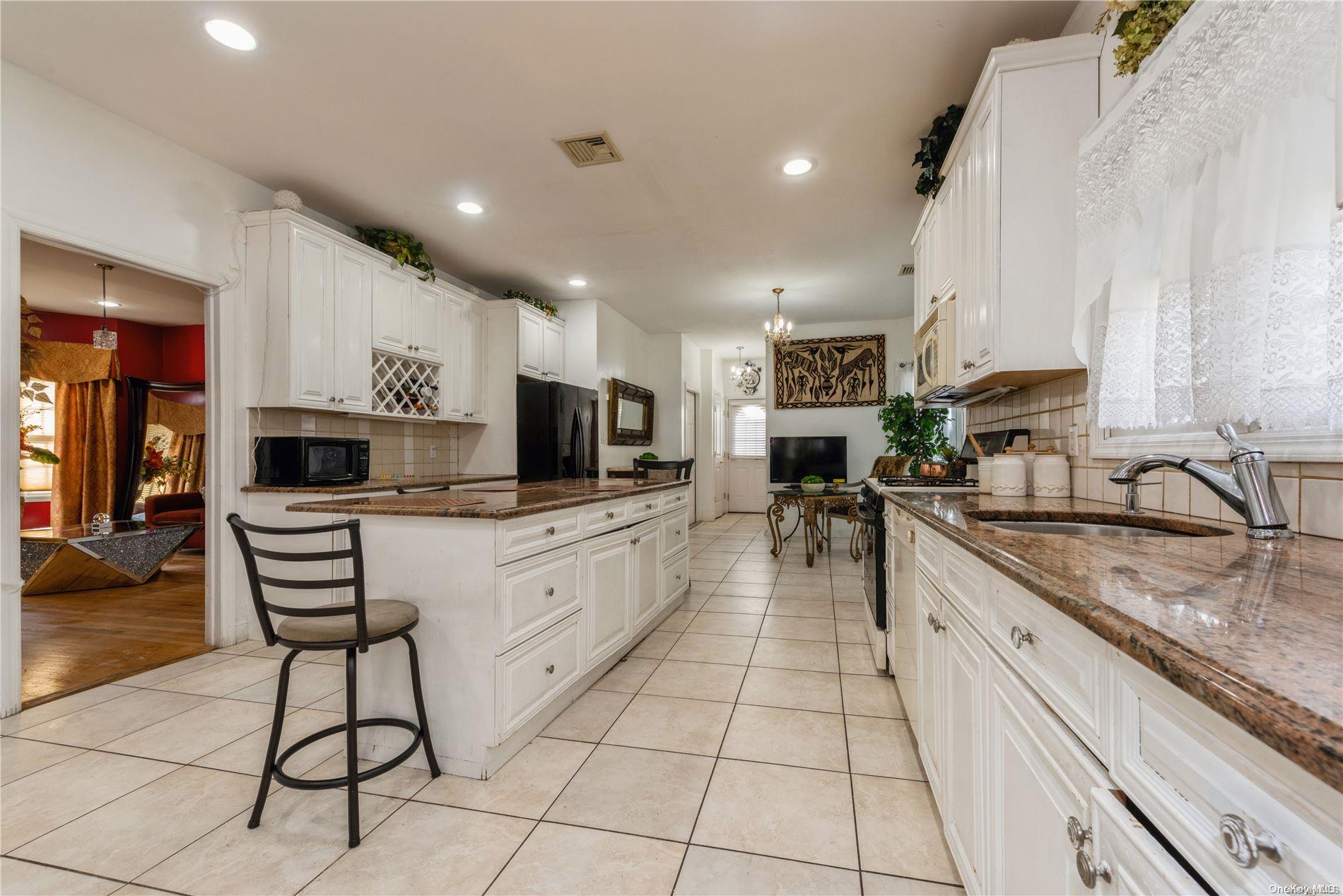 968 Bowe Road Valley Stream, NY 11580 - Photo 14 of 36 a large kitchen with cabinets