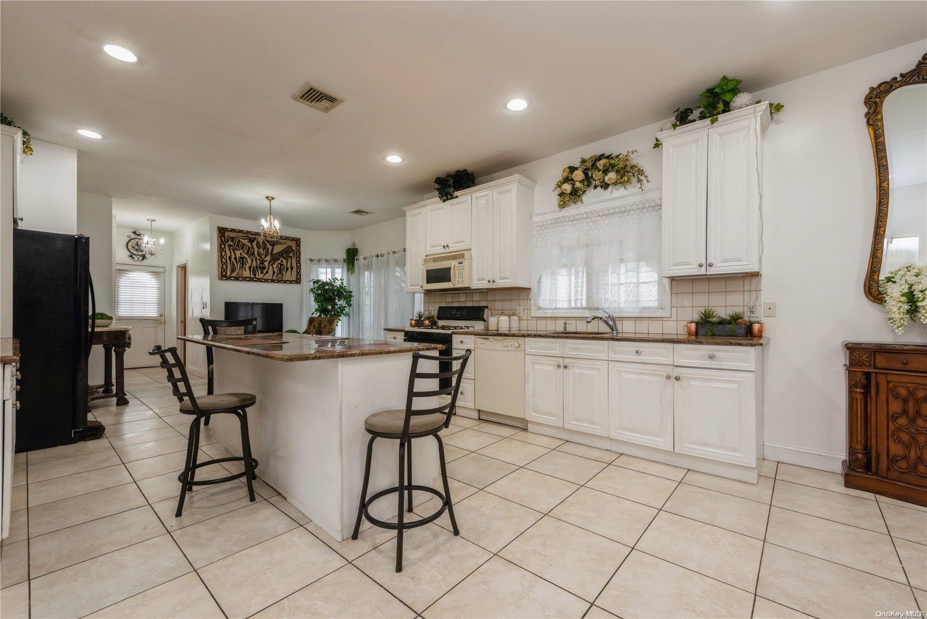 968 Bowe Road Valley Stream, NY 11580 - Photo 15 of 36 a kitchen with appliances cabinets and a counter top space