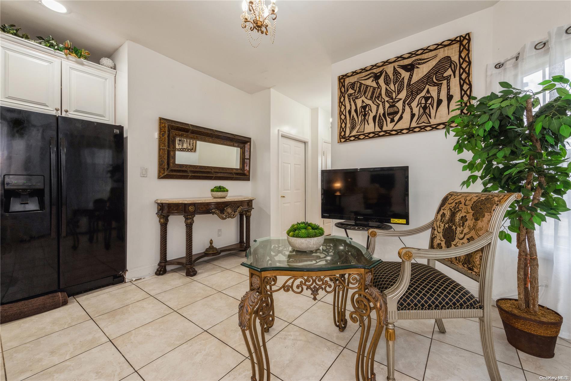 968 Bowe Road Valley Stream, NY 11580 - Photo 18 of 36 a view of a livingroom with furniture and flat screen tv