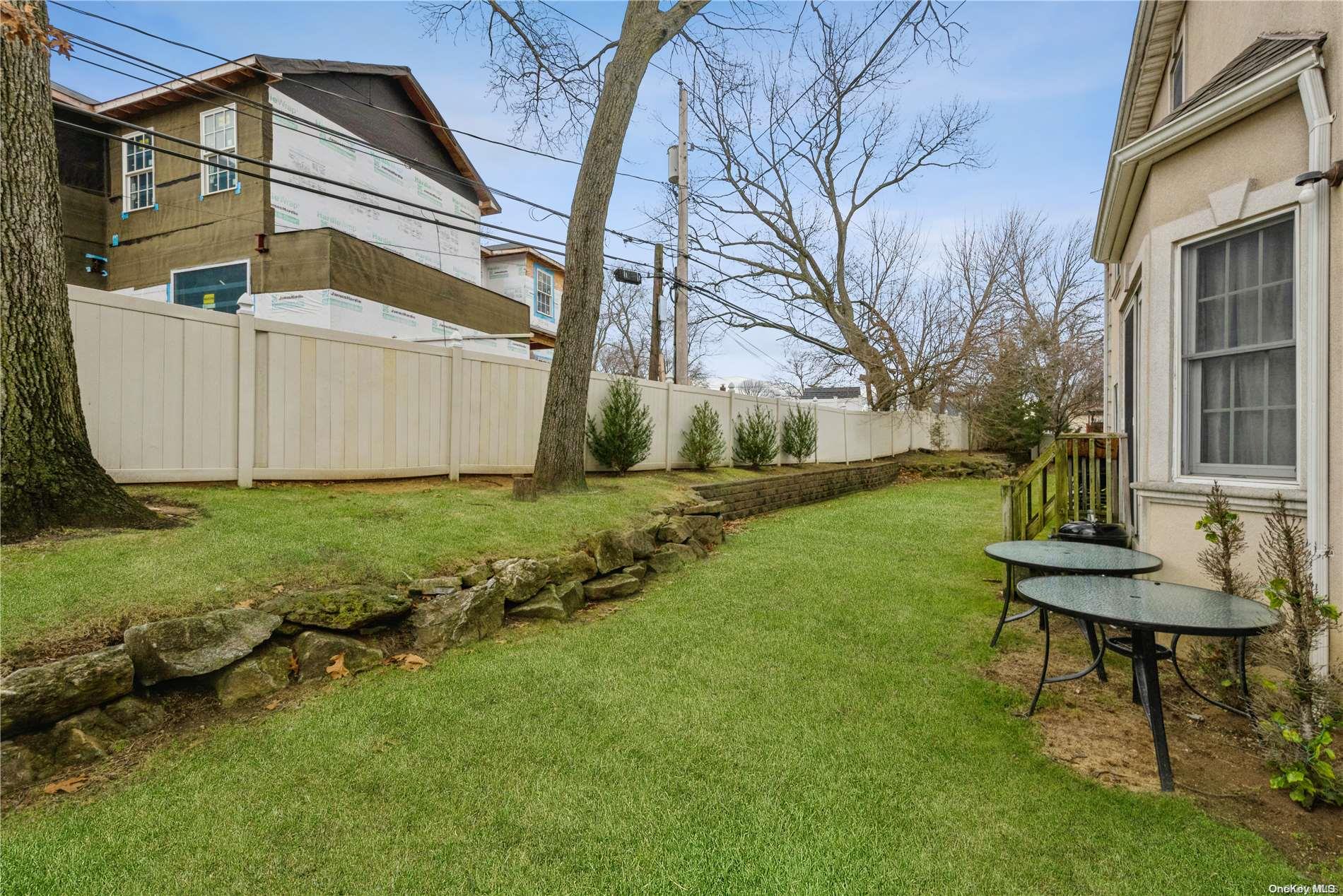 968 Bowe Road Valley Stream, NY 11580 - Photo 34 of 36 a view of a chair and table in backyard of the house