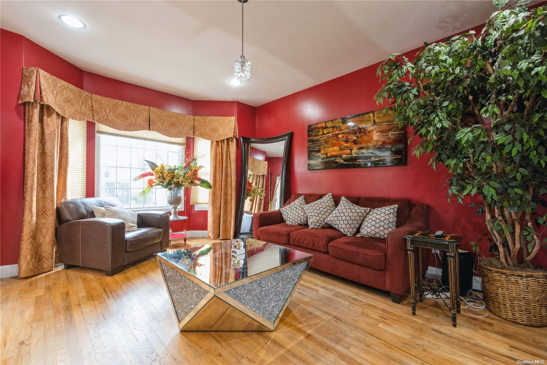 968 Bowe Road Valley Stream, NY 11580 - Photo 7 of 36 a living room with furniture lamps and a large window