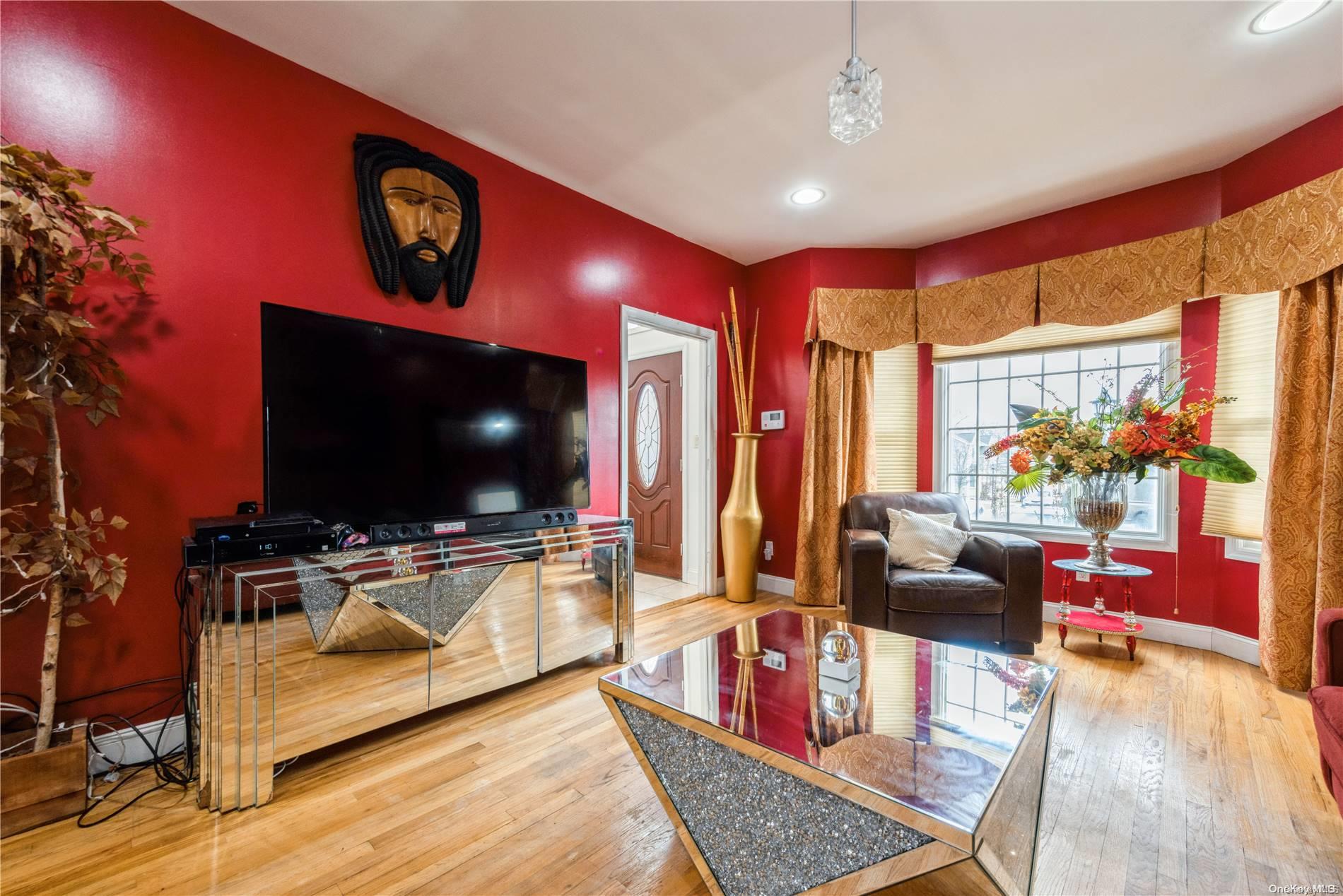 968 Bowe Road Valley Stream, NY 11580 - Photo 8 of 36 a living room with furniture and a flat screen tv