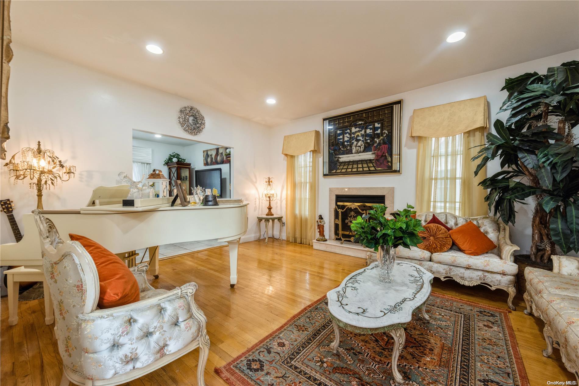 968 Bowe Road Valley Stream, NY 11580 - Photo 9 of 36 a living room with fireplace furniture and a fireplace