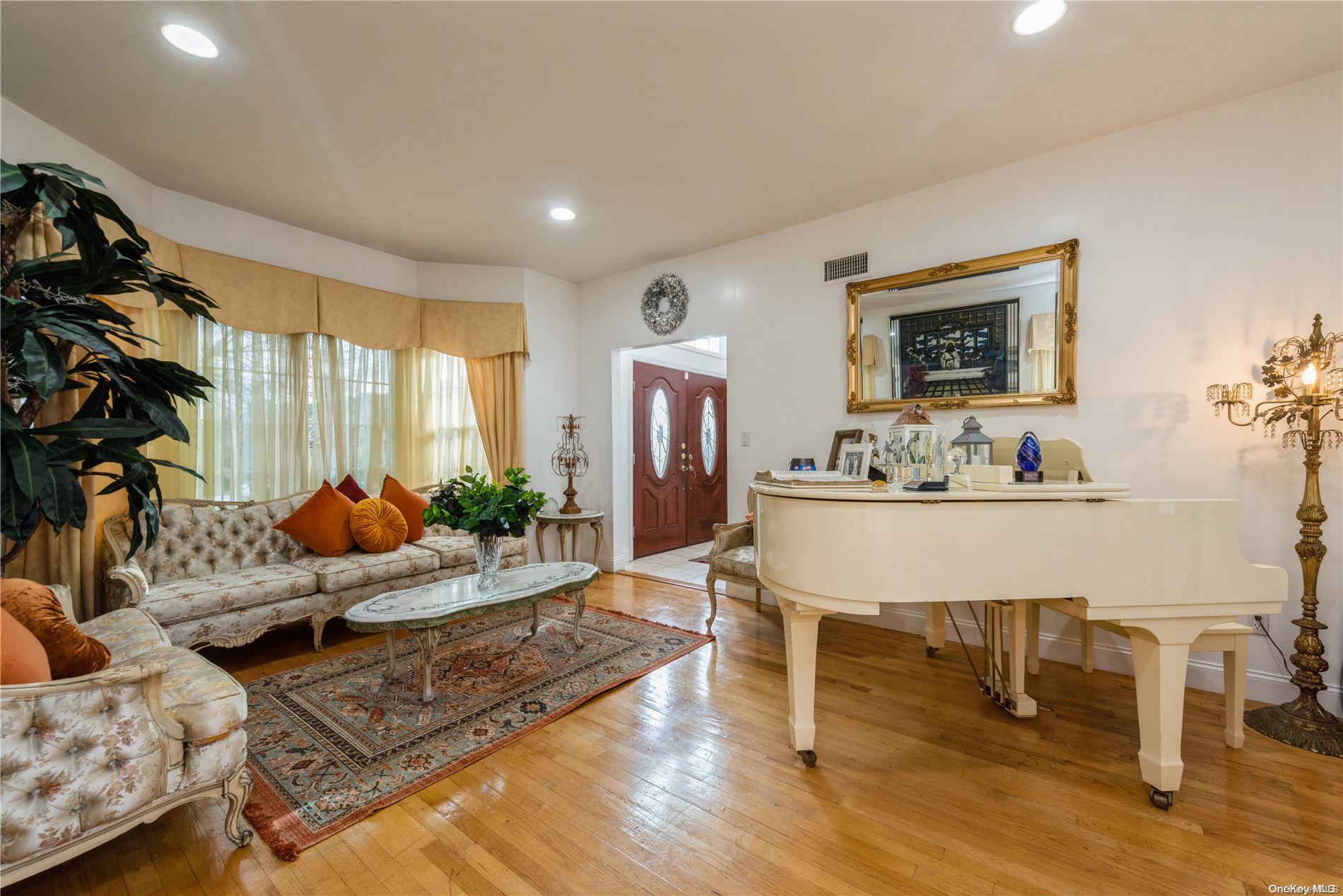 968 Bowe Road Valley Stream, NY 11580 - Photo 10 of 36 a living room with furniture kitchen view and a wooden floor