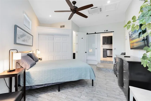 a bedroom with a bed and a chandelier