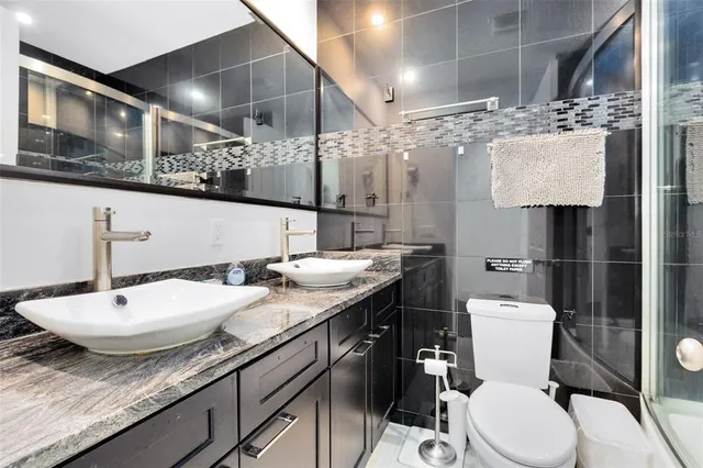 a backyard of a house with barbeque oven table and chairs