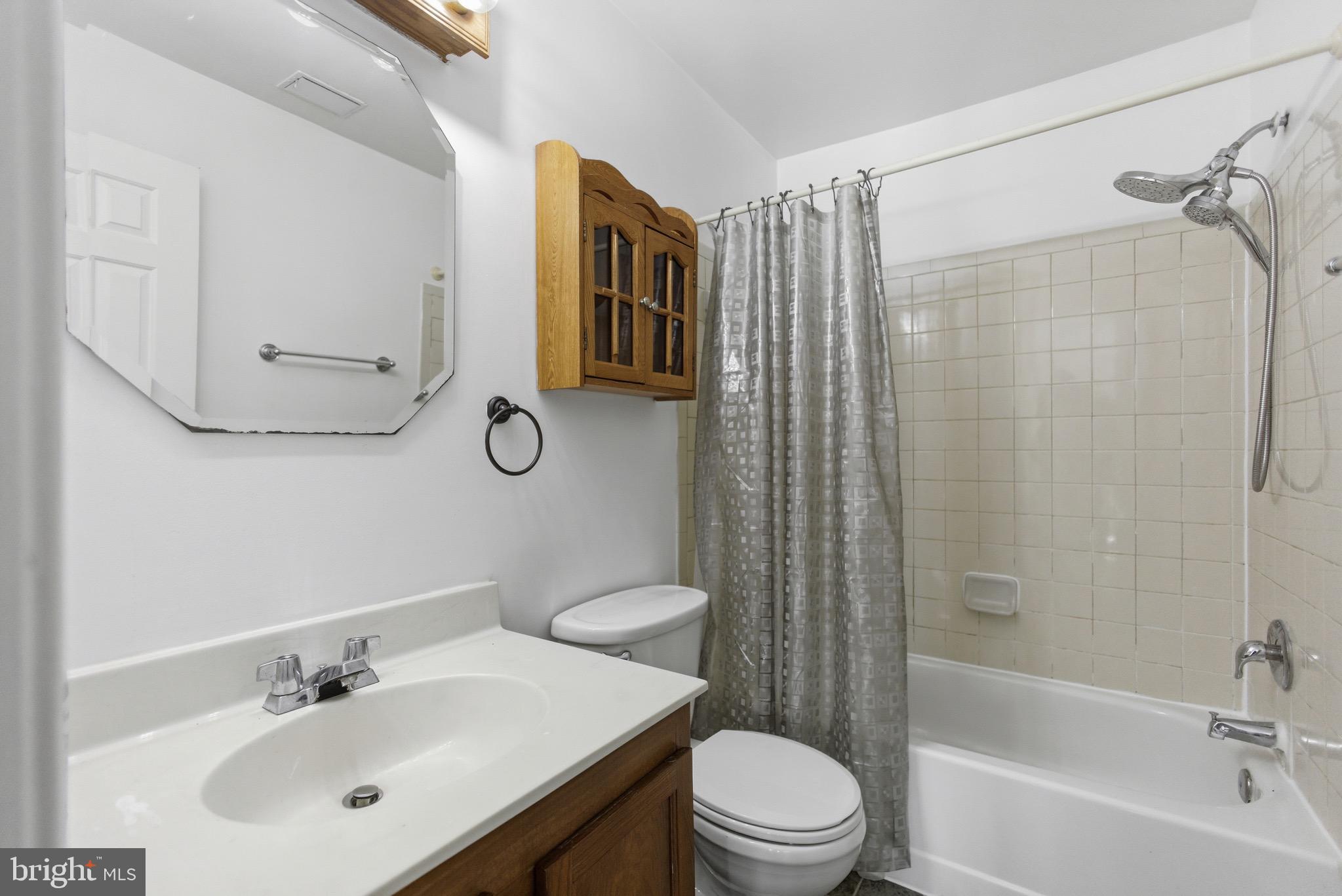 20565 Shadyside Way Germantown, MD 20874 - Photo 16 of 17 a bathroom with a toilet sink vanity tub and shower