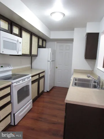 a kitchen with stainless steel appliances a stove microwave and sink