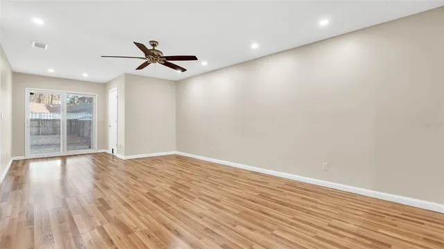 an empty room with chandelier fan