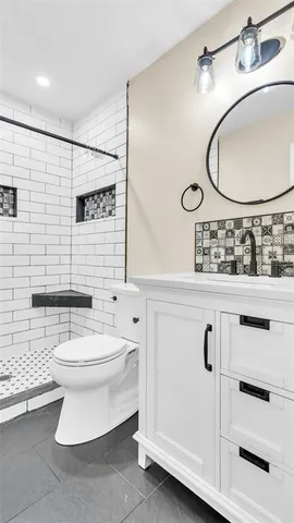 a view of empty room with wooden floor and ceiling fan