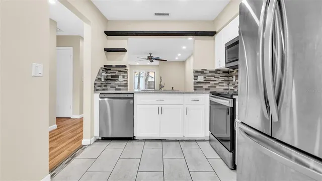 an empty room with a empty space and a ceiling fan