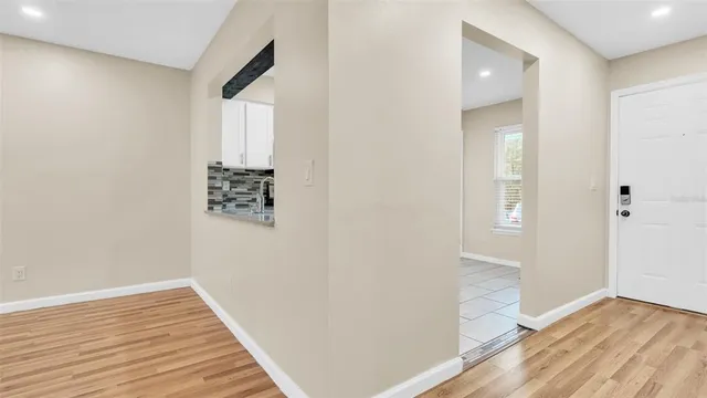an empty room with a ceiling fan and a window