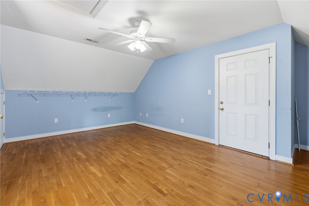 15441 Goshen Road Montpelier, VA 23192 - Photo 40 of 47 an empty room with wooden floor and chandelier fan