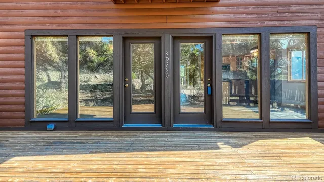 a view of a living room kitchen and floor to ceiling window