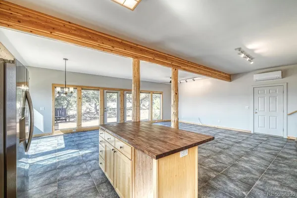 a open kitchen with granite countertop a sink and a refrigerator