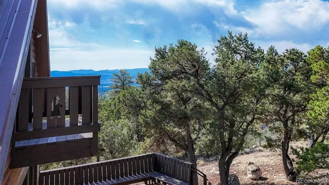 a view of balcony with wooden floor and fence