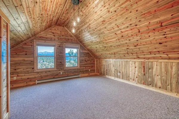 a view of a backyard with brick wall and iron fence