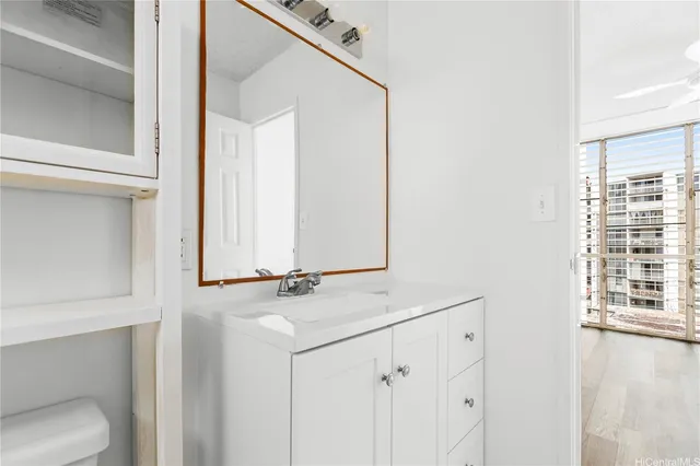 a bathroom with a sink a toilet and a window