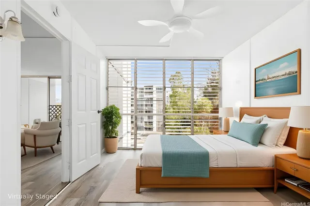 a bedroom with a balcony and a large bed